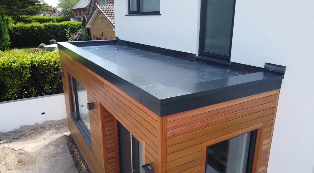 Single ply flat roof on a timber-clad garden room