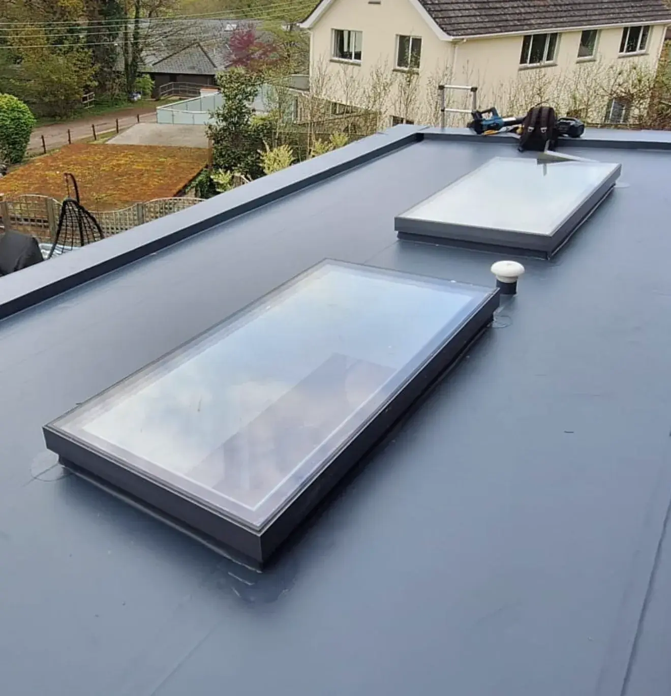 Two flat skylights sealed into a single ply membrane roof